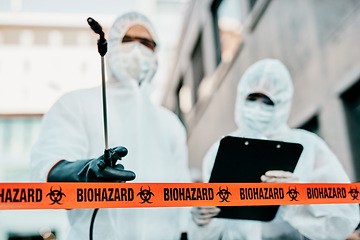 Image showing Covid, pandemic and team of doctors, scientist or medical healthcare workers wearing hazmat suit to prevent the spread of virus at a quarantine site. First responders sterilizing the infected area.