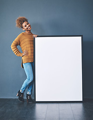 Image showing Sign, board and copyspace being held by a beautiful young woman for an advert. Attractive, smiling and happy female standing with a blank announcement to voice opinion. Lady with an empty poster.