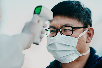 Image showing Covid temperature scanning a man head or healthcare worker doing protocol, routine checkup of patient arriving at the airport or border. Traveling refugee or foreign man with face mask in quarantine