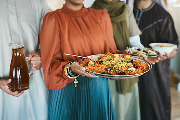 Image showing Ramadan, Eid and iftar with a muslim family holding food and drink to break their fast at home together. Closeup of rice and curry in the hands of a woman with people holding other meals and juice