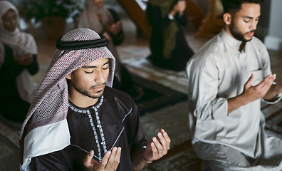 Image showing Religion, Arabic and Muslim family praying, kneeling and worshipping together in an Islamic Mosque to honor and God. A religious, traditional and spiritual group of holy men on Eid Ramadan on carpets