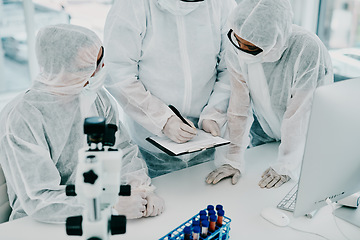 Image showing Team of scientists, pathologists and doctors in hazmat suits discussing forensic research and plans in a lab. Medical experts working on tests, experiments and drug trial to develop cure for disease