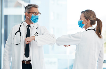 Image showing Doctors doing covid safe greeting with elbow, wearing face mask to protect from virus and working in a hospital. Heathcare workers talking at a clinic, prevent spread of disease and showing support