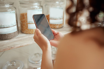 Image showing Grocery store customer with a phone shopping, browsing and searching for a local supermarket product, spice and ingredient. Woman hands researching, choosing and deciding on a healthy cooking food