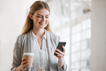 Image showing Phone, coffee and online of a young employee texting on smartphone in a corporate office. Happy, smile and mobile woman on the internet at work networking, news and social media at the office.