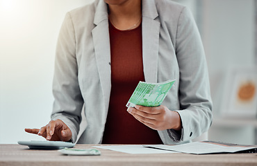 Image showing Banking, accounting and finance with an insurance broker or moneychanger typing on a calculator, comparing currency and exchange rates. Closeup of a business woman holding cash, money or bank notes