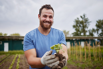 Image showing Happy farming worker with a plant on an agriculture farm with a smile. Farmer advertising sustainability, growth and ecology on a green field or land in a nature eco friendly environment countryside