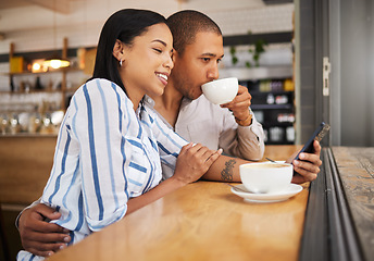 Image showing Couple using social media on a phone and drinking tea in a coffee shop together. Happy man and woman with 5g mobile smartphone texting and searching on an online app and enjoy a date at a cafe