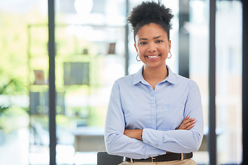 Image showing Success, leadership and professional businesswoman smiling while in a modern corporate office. Portrait of a confident worker, manager and young female leader standing with crossed arms at a company.