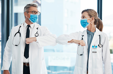 Image showing Elbow greeting, doctors and medical healthcare workers with covid 19 virus safety masks in a hospital portrait. Life, emergency and wellness social distancing to stay safe. Employee ready for service