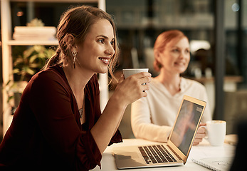 Image showing Young, happy and smiling female students enjoying a cup of coffee in a cafe or restaurant while working late at night. .Team of university learners doing research for a college project or assignment