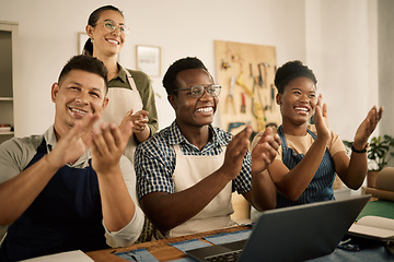 Image showing Clapping, cheering and excited fashion design team celebrate at workplace. Coworkers welcome and support employee promotion. Diverse group of happy, smiling creatives celebrating in a workshop.