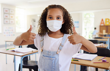 Image showing Thumbs up for education with covid, school student pleased with learning wearing a mask and showing support in a classroom at school. Portrait of a little girl protecting from virus during pandemic