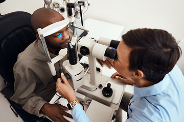 Image showing Eye, vision or sight test or exam of a patient above at an optometrist, optician or ophthalmologist. Testing and checking eyesight on a ophthalmoscope for optical glasses or contact lenses at clinic.