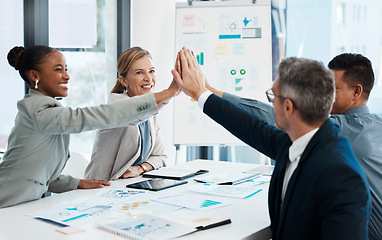 Image showing High five, success and motivated business group celebrating innovation deal, promotion or profits. Diverse executive team with growth mindset cheering and analyzing report data in boardroom meeting