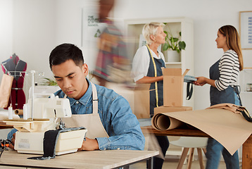 Image showing Man working in fashion design shop, making unique clothing and doing tailor job at a factory, boutique or studio at work. Serious male designer, stylist or employee designing clothes with equipment