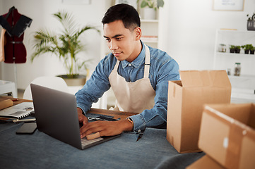 Image showing Creative startup, online order and designer in his fashion studio workshop on a laptop. Internet as a marketplace for ecommerce to advertise and sell products before packaging and delivery by courier