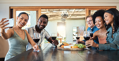 Image showing Diverse friends taking selfie on a phone while bonding, drinking wine and eating together at a restaurant. Fun group enjoying gathering, reunion, laughing, talking and celebrating friendship