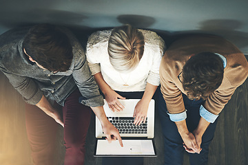Image showing A group of planning, researching and professional business people working together on a laptop while sitting on the floor top view. A team of designers searching the web or completing a project