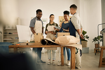 Image showing Creative teamwork, fashion and clothes making team looking at fabric at a design studio. Group of clothing designers planning a work collaboration project or style presentation together indoors