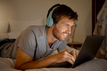 Image showing Laptop, video and man streaming a movie in his bedroom on tv via internet while relaxed, smile and enjoying content. Headphones, house and happy male watching series on computer pc at night at home