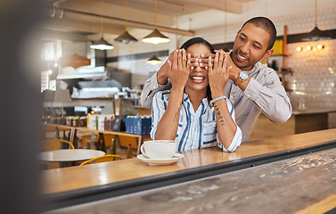 Image showing Wow, surprise and romantic boyfriend covering his girlfriends eyes for a present at a restaurant, coffee shop or cafe store. A happy birthday gift to celebrate their love, couple and woman together