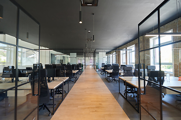 Image showing In a setting of modern, glass-walled business startup offices, the open, airy workspace reflects a contemporary and innovative ambiance, promising a dynamic environment for entrepreneurial growth