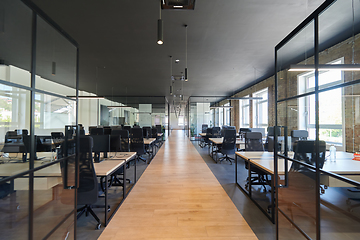 Image showing In a setting of modern, glass-walled business startup offices, the open, airy workspace reflects a contemporary and innovative ambiance, promising a dynamic environment for entrepreneurial growth