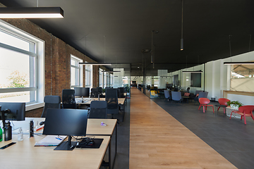 Image showing In a setting of modern, glass-walled business startup offices, the open, airy workspace reflects a contemporary and innovative ambiance, promising a dynamic environment for entrepreneurial growth