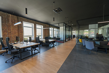 Image showing In a setting of modern, glass-walled business startup offices, the open, airy workspace reflects a contemporary and innovative ambiance, promising a dynamic environment for entrepreneurial growth