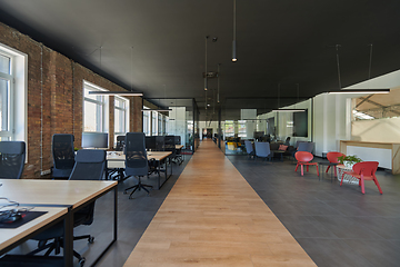 Image showing In a setting of modern, glass-walled business startup offices, the open, airy workspace reflects a contemporary and innovative ambiance, promising a dynamic environment for entrepreneurial growth