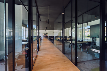 Image showing In a setting of modern, glass-walled business startup offices, the open, airy workspace reflects a contemporary and innovative ambiance, promising a dynamic environment for entrepreneurial growth