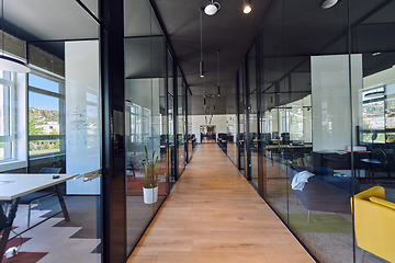Image showing In a setting of modern, glass-walled business startup offices, the open, airy workspace reflects a contemporary and innovative ambiance, promising a dynamic environment for entrepreneurial growth