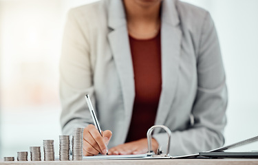 Image showing Bank, coins and hands writing in tax files for financial year or consulting at work desk. Economy, money and accountant working on corporate documents and administration for management.