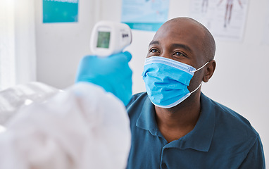 Image showing Man doing covid temperature check with medical doctor, checking for fever during checkup and wearing a mask to protect from virus. Expert, professional or healthcare worker consulting and doing exam