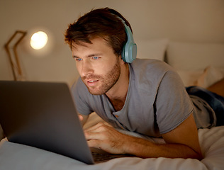 Image showing Online, laptop and late night stream or work in the bedroom. Man using internet on pc to watch series, esports or gaming to relax. Stress management and entertainment with online technology at home.