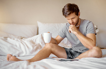 Image showing Relax, bedroom and thinking man working on magazine puzzle game or quiz at airbnb or hotel room. Young male drinking coffee after waking up from sleep in the morning, and reading brochure book in bed