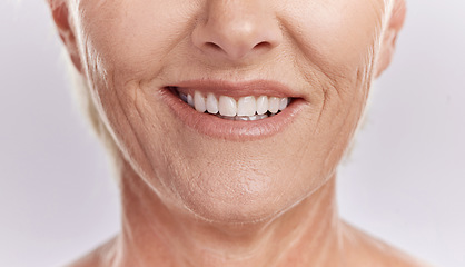 Image showing Happy woman with teeth and smile, showing her natural looking dental veneers posing against a purple mockup studio background. Model woman happy with her oral healthcare hygiene and health skincare