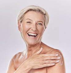 Image showing Sunscreen, skincare and body care of senior woman applying cream to skin with a studio portrait. Skin care, clean and hygiene model with anti aging wrinkles or moisturizing product for aging wellness