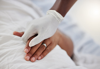 Image showing Doctor, healthcare worker and medical professional holding hands to show support, consulting with sick hospital patient and giving healthcare to person. People helping with insurance and surgery