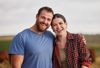 Image showing Happy, carefree, and excited farmer couple standing outdoors on cattle or livestock farmland. Portrait of relaxed lovers relaxing on organic or sustainable land smiling and enjoying nature