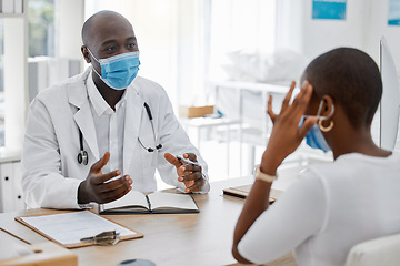 Image showing Doctor appointment by a woman with a headache or covid symptoms consulting a healthcare professional at the hospital. Black male medical worker or GP has a consultation with an ill or sick patient