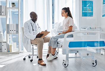 Image showing Doctor, healthcare and man talking to girl patient about documents, medicine and health in a hospital. Medical worker consulting insurance and working to help woman at the clinic.