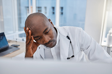 Image showing Stress, anxiety and sad doctor at work on computer, sick and headache in a hospital or clinic. Medical professional or healthcare worker in depression, burnout and working and thinking about health.