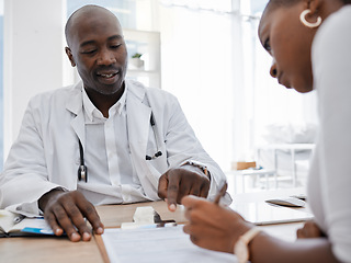 Image showing Doctor, patient and signing insurance paper while talking and pointing at consent form in clinic, hospital and health center. Consulting, medical checkup and medicine research with healthcare worker