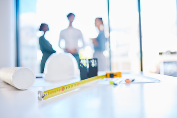 Image showing Creative engineering designer discuss building plans in a corporate business. Measure tape on a table or desk in an architecture company office with engineer employee consulting in the background