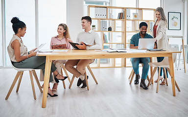 Image showing Business people working in an office together, doing interview and talking in meeting at work. Group of professional colleagues, workers and employees in common area, hiring and planning with laptop