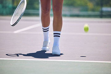 Image showing Fitness, tennis and sports legs of woman with racket and ball walking on court after serving in training, workout or exercise. Sporty shoes, active or healthy player losing match, game or competition