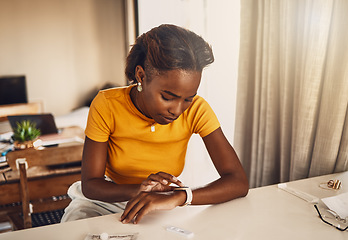 Image showing Young, worried and stressed black woman waiting for the results of covid test. African American woman looking at the time on a smart watch and anxious or fearful about her medical and health status