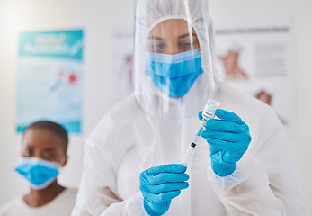 Image showing Vaccine, injection and medicine cure for covid, monkeypox and ebola with doctor, healthcare or medical professional. Frontline worker in hazmat suit getting ready to inject clinic or hospital patient